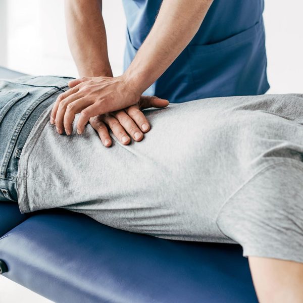 Someone laying down and receiving a chiropractic adjustment.