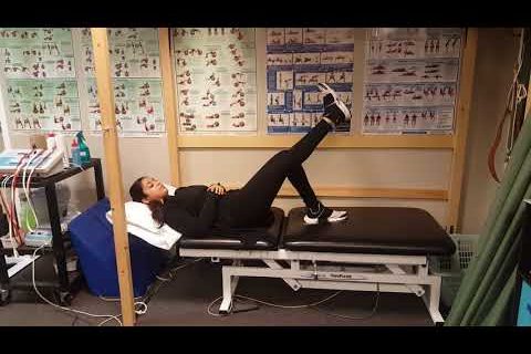 Someone performing a straight leg raise exercise.