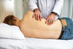 A man laying on his side receiving chiropractic treatment