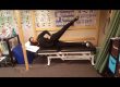 Someone demonstrating the sidelying hip abduction exercise.