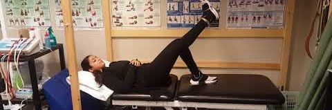 Someone performing a straight leg raise exercise.